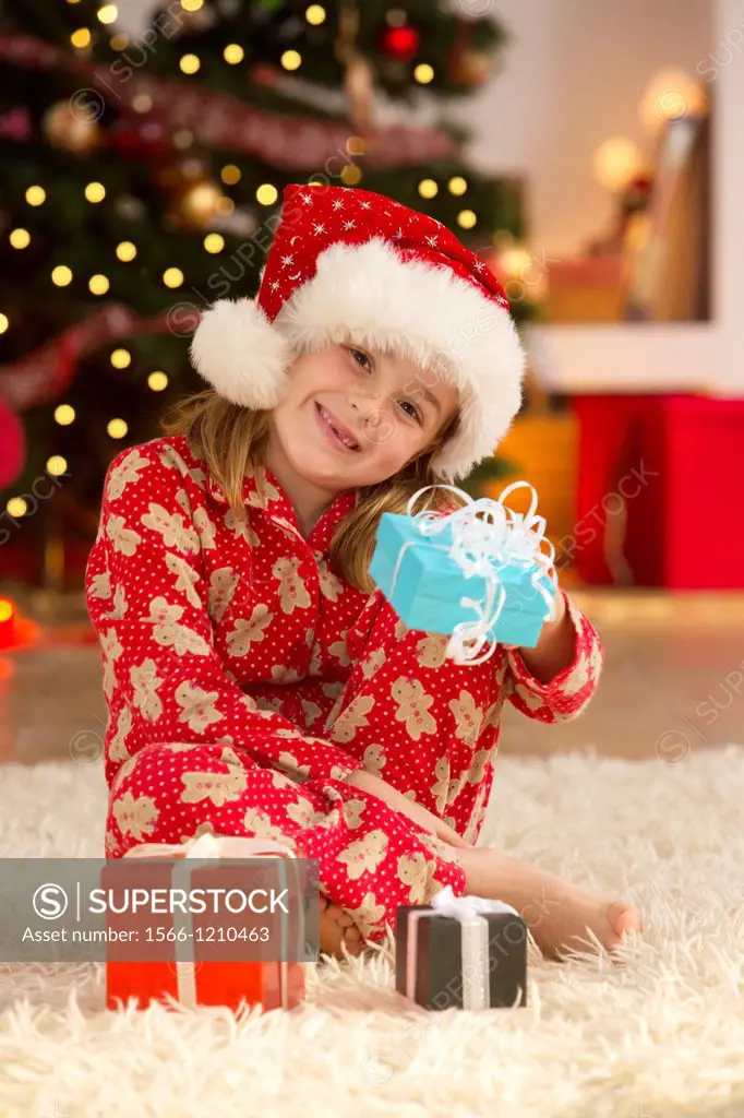 Young girl with gifts at Christmas time