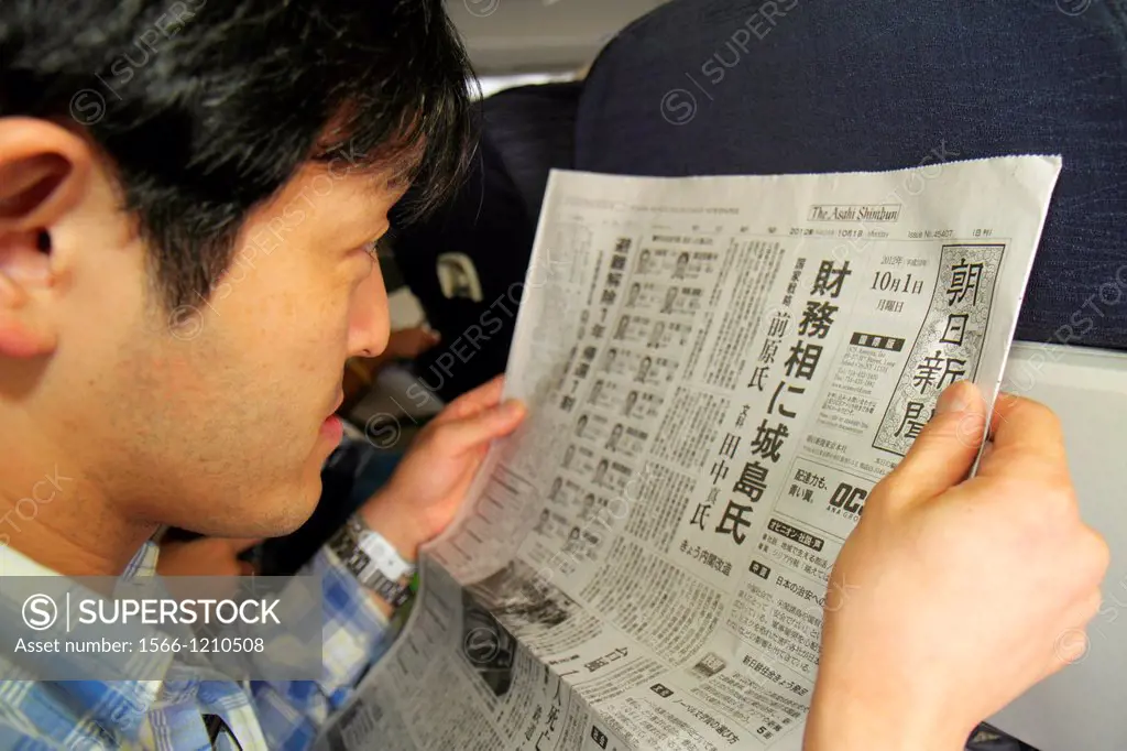 Illinois, Chicago, O´Hare International Airport, ORD, onboard, United, commercial airliner, cabin, Asian, man, reading, passenger, Japanese, language,...