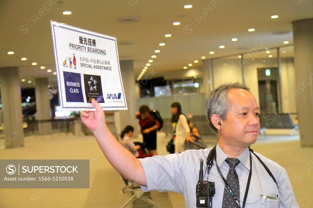 Japan, Tokyo, Narita International Airport, NRT, gate area, concourse, ANA, Al Nippon Airways, Asian, man, uniform, holding, sign, priority boarding, ...
