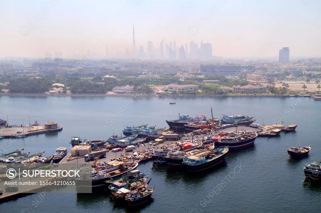 United Arab Emirates, U A E , UAE, Middle East, Dubai, Dubai Creek, port, cargo, boats, ships, dhow wharfs, distant Downtown Dubai, Burj Khalifa, worl...