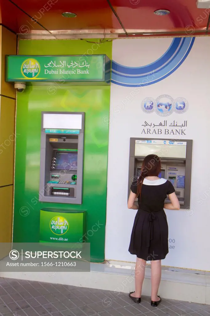 United Arab Emirates, U A E , UAE, Middle East, Dubai, Deira, Al Rigga, Al Maktoum Road, Dubai Islamic Bank, Arab Bank, ATM, self-service, woman, Engl...