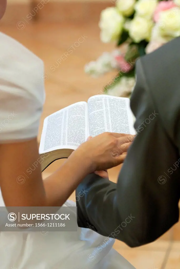 Couple reading together Bible during Christian wedding ceremony, Firenze, Tuscany, Italy