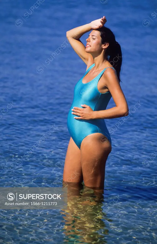 Pregnant woman standing in sea