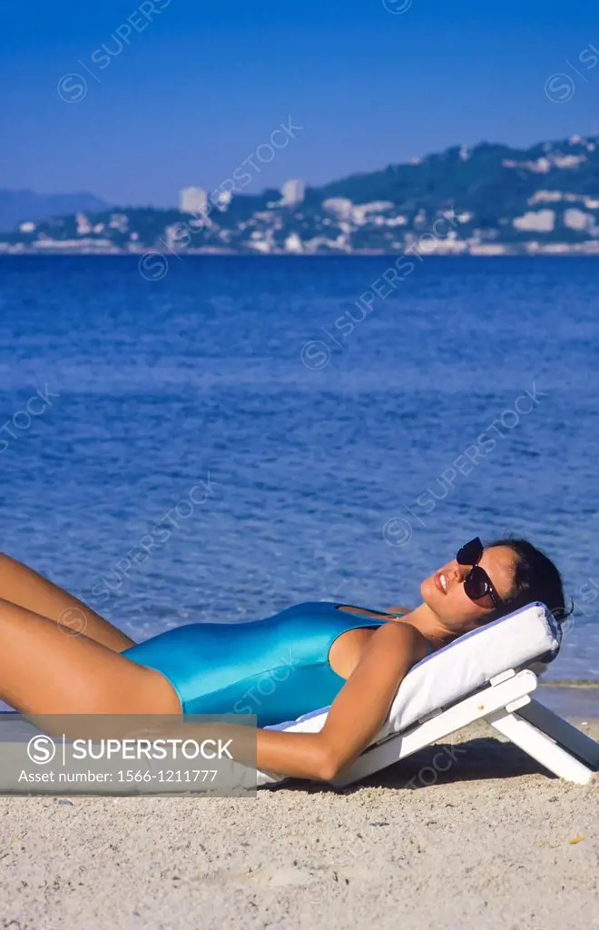 Pregnant woman sunbathing on beach