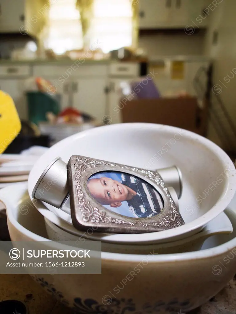 A kid´s school picture in dishes inside a foreclosed home in Haw River, North Carolina, United States