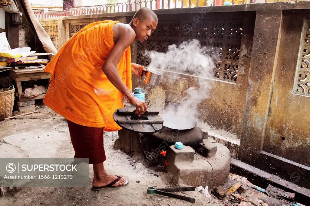 Monk at work boiling water, burman novice, Myanmar, Burma, Asia