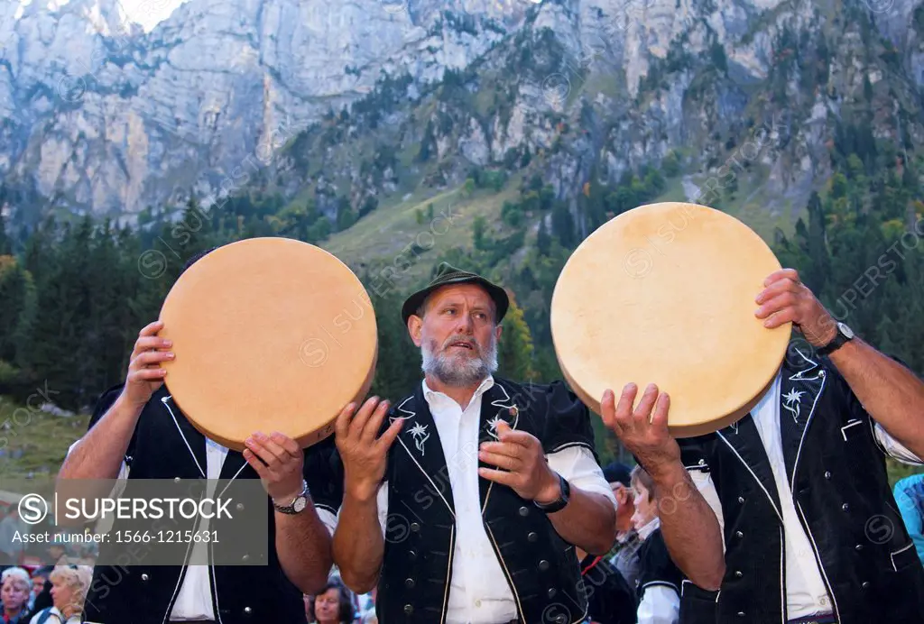 Shepherds hand-carry round Swiss alpine cheese truckle from the storage house for distribution at the Chästeilet event in the Justis Valley, when the ...