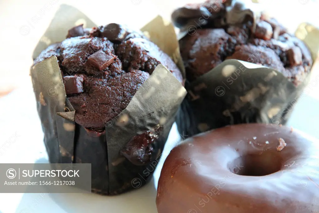 Chocolate muffins and doughnuts on plate