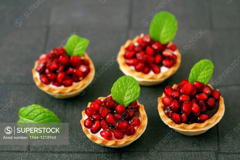 Tartlets with cheese and pomegranates