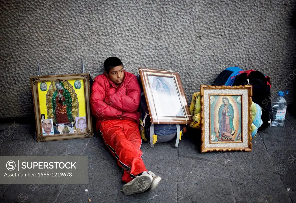 A pilgrim sits by images of Our Lady of Guadalupe virgin in Mexico City, December 6, 2008  Hundreds of thousands of Mexican pilgrims converged on the ...