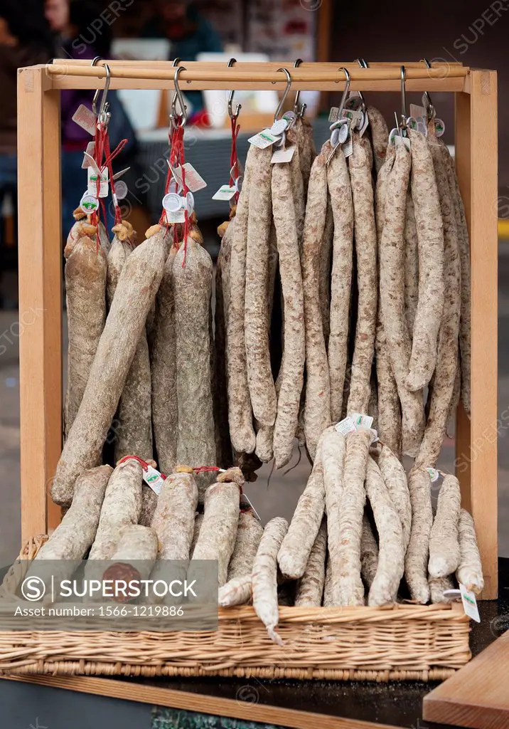 Selection of salami sausage hanging up in a market stall
