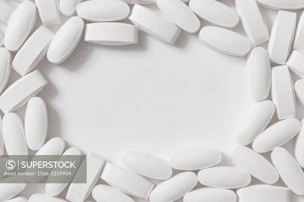 Generic White Lozenge Shaped Pills on a White Background with a space for copy