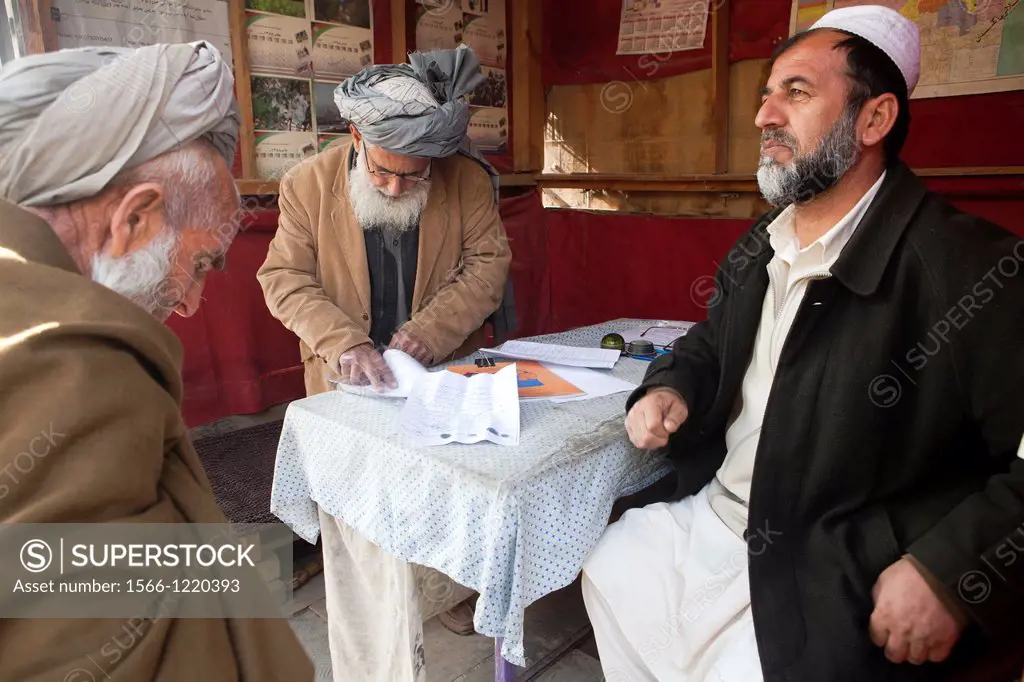 An Afghan lawyer talks to clients, Kunduz, Afghanistan