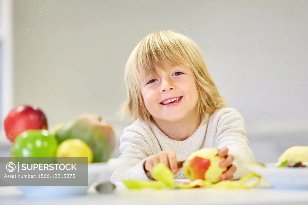 Family in the kitchen. Child. Healthy eating. Healthy growth. Eating an apple.