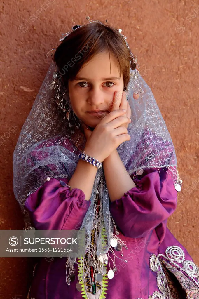 Portrait of a young iranian girl wearing traditional floreal chador, Abyaneh, Iran