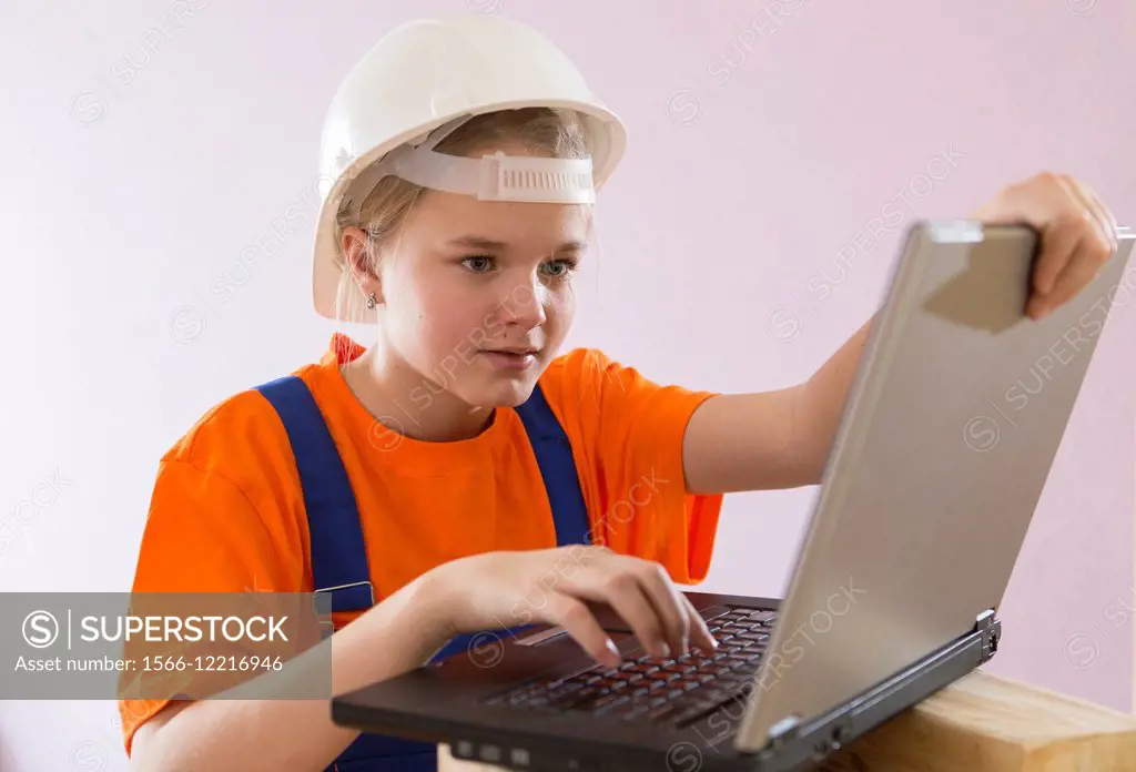 Beautiful girl-builder with a computer.