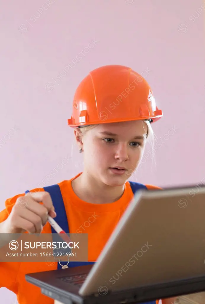 Beautiful girl-builder with a computer.