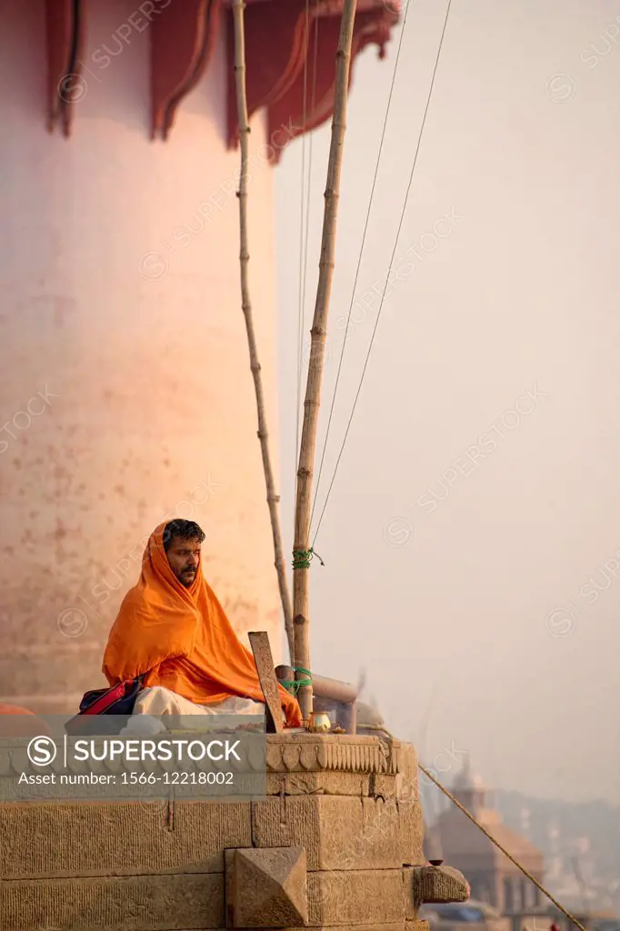 Pilgrim sitting at the ghats of Varanasi.