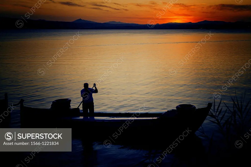 Boatman at sunset in Albufera Lake, Valencia, Spain.