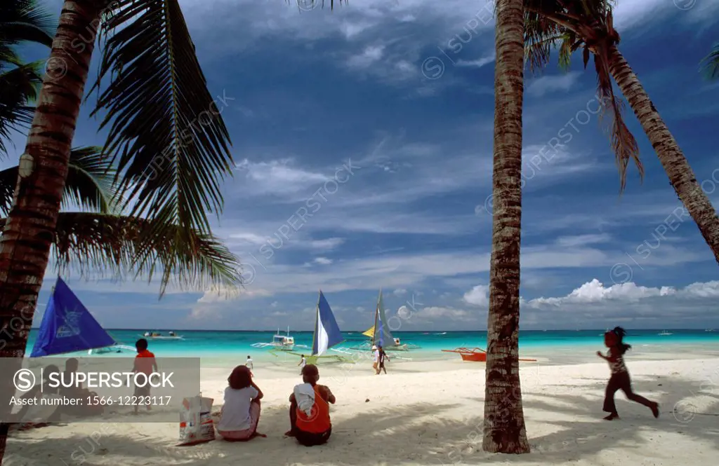Landscape with palm trees. Bankas in White beach. Boracay. Philippines. Boracay is a small island in the Philippines located approximately 315km (19...