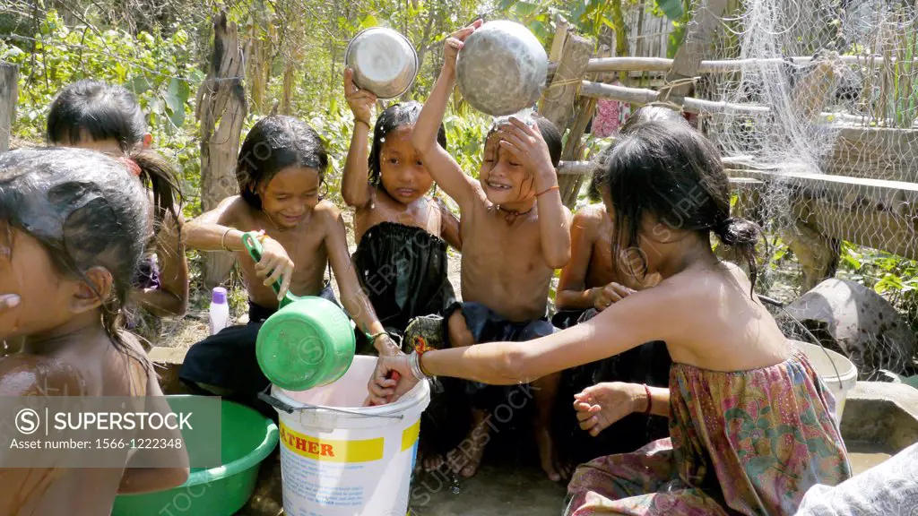 CAMBODIA. Projects of DPA in Stung Treng, supported by SCIAF. Phluck village  Children enjoying themselves washing at the well