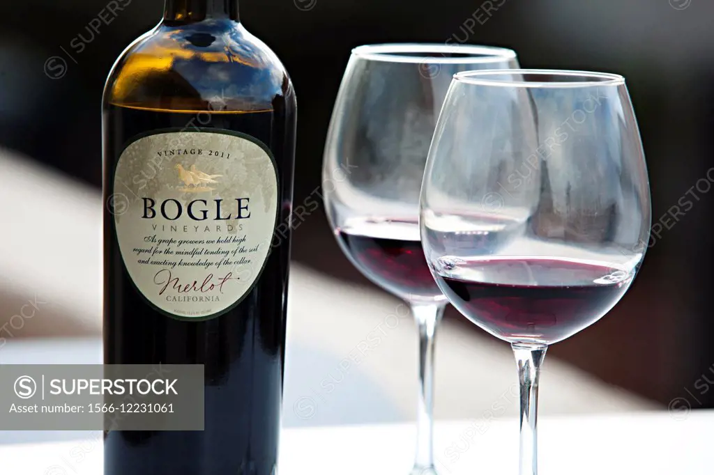 Bogle Merlot wine are poured in two wine glasses on a balcony
