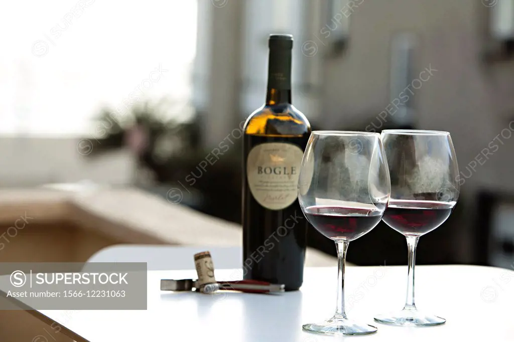 Bogle Merlot wine are poured in two wine glasses on a balcony