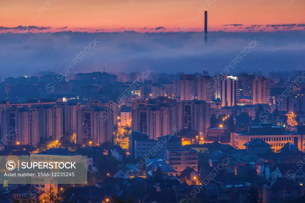 Romania, Transylvania, Brasov, new city and CET Brasov thermal energy plant, dawn.