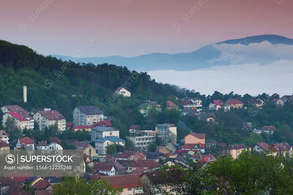 Romania, Transylvania, Brasov, town buildings in fog, dawn.