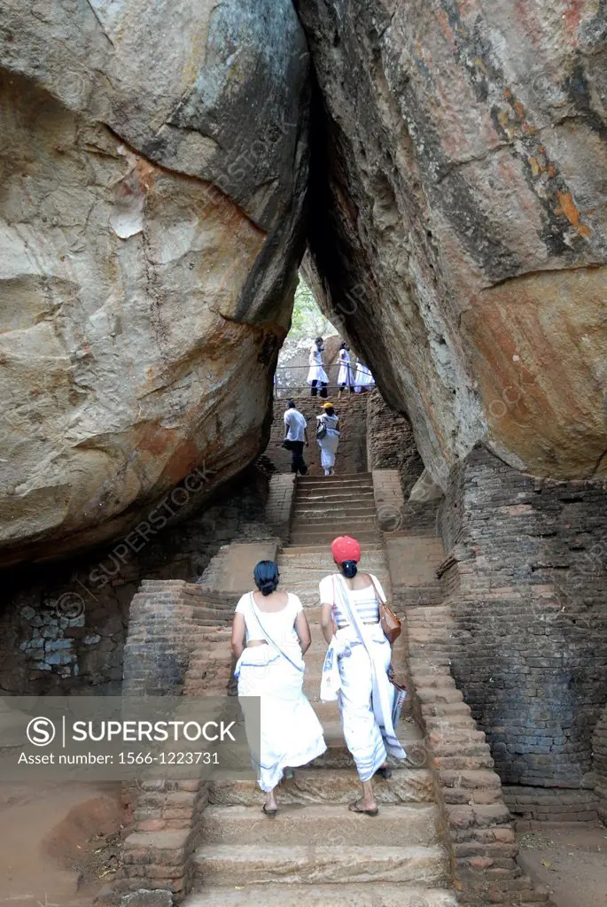 two women climbing the steps to the lions terrace at Sigiriya, Sri Lanka