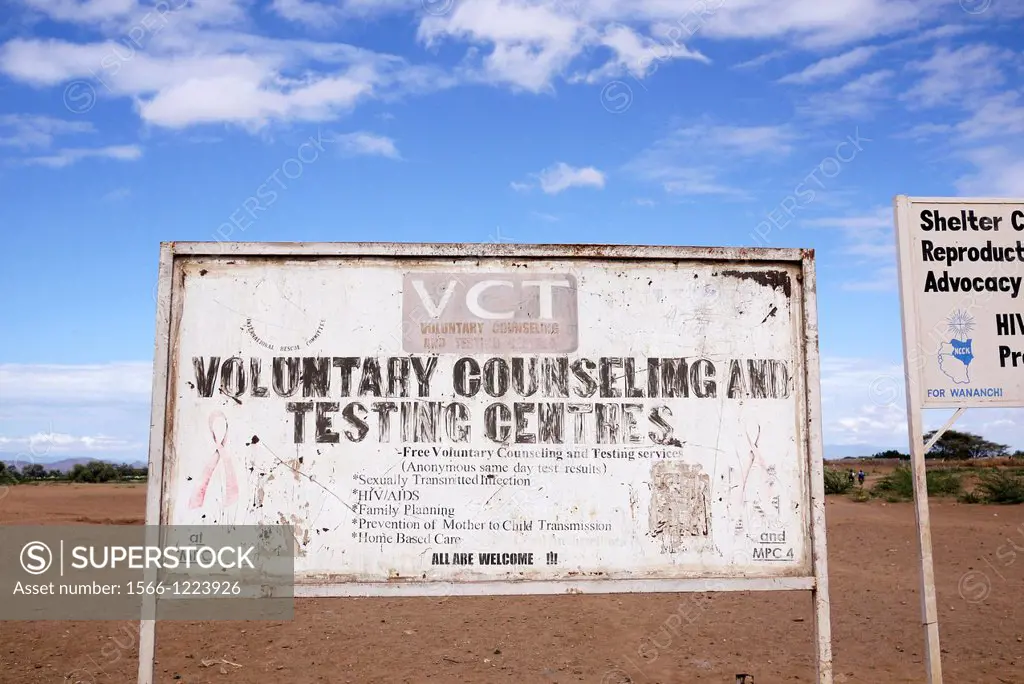 Kenya. Signs for various NGOs on the road outside the refugee camp at Kakuma, Turkana.