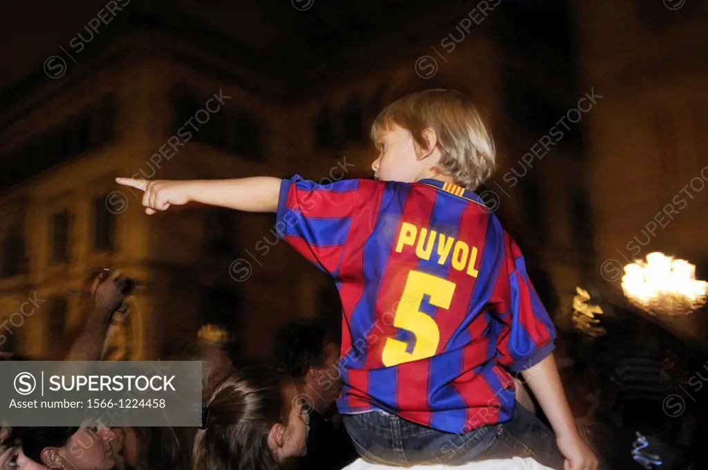Child with shirt of Barcelona football club pointing. Barcelona, Catalonia, Spain