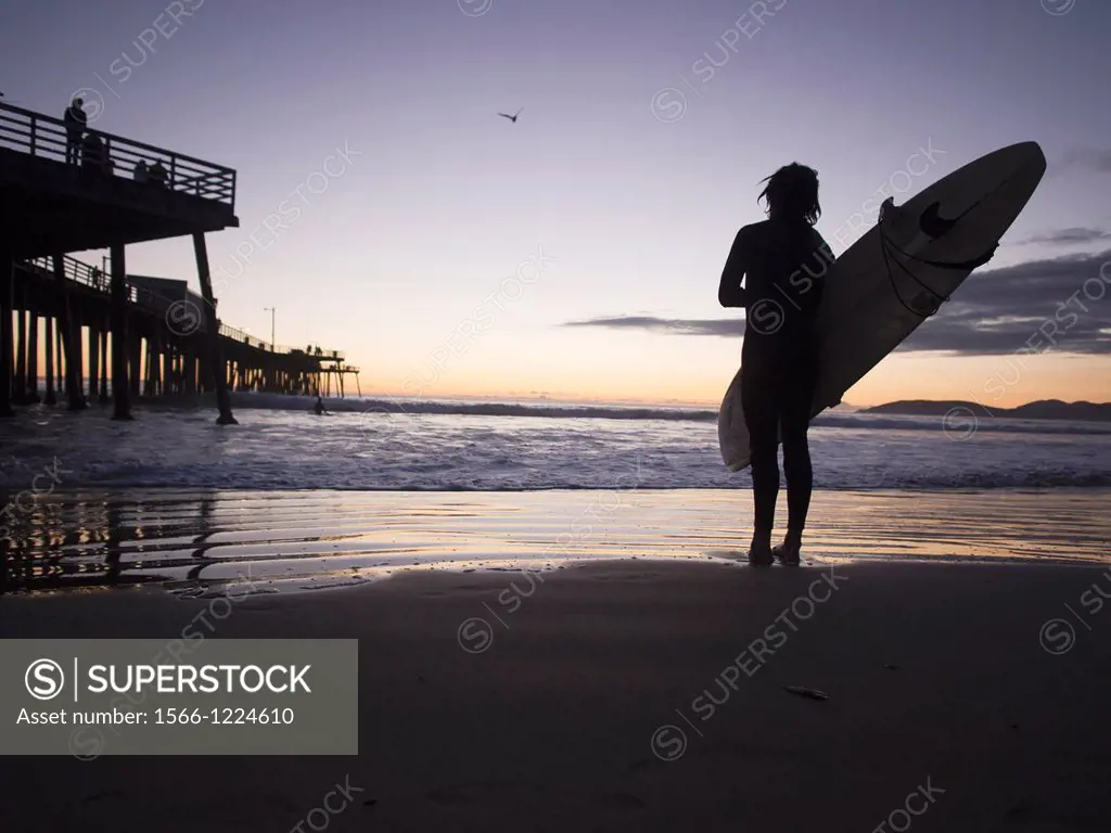Surfer on the beach in pismo Beach, California