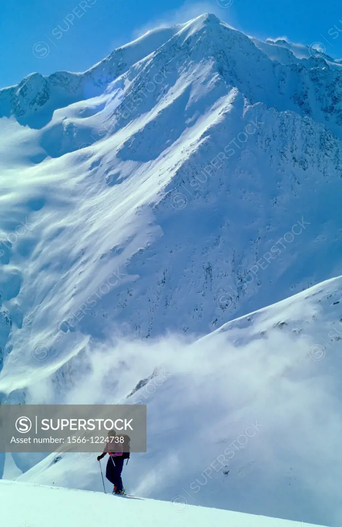 One man on ski walking uphill in remote part of Otztal Alps, Austria