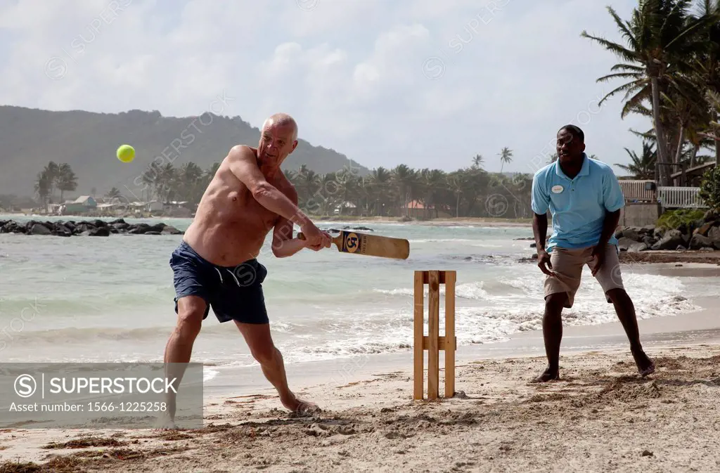 Tourist playing beach cricket, St Lucia,