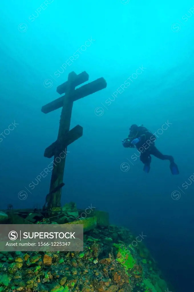 The diver looks at a cross ´This cross is consecrated and established on Feast of the Ascension 09 06 2005´  Lake Baikal, Siberia, the Russian Federat...