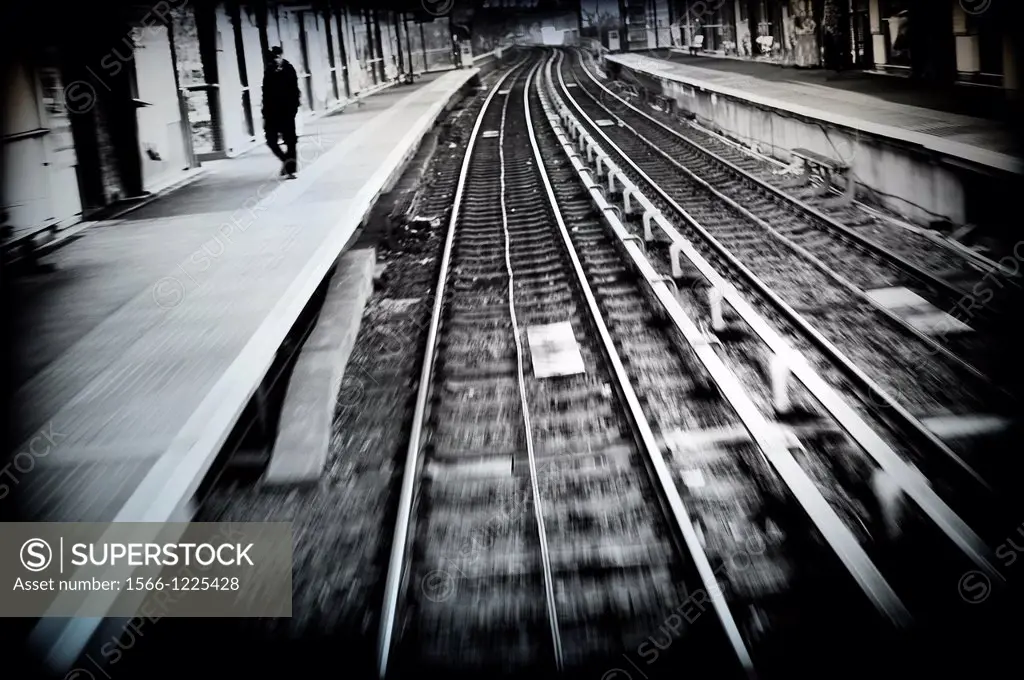 Loner on the platform of a train station,