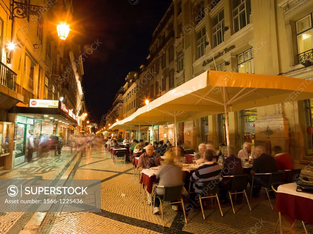 Portugal Lisbon. People in outdoor restaurant in Rua Augusta at evening.