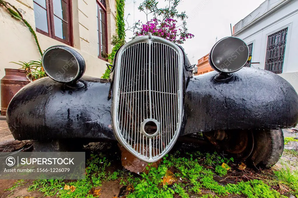 Old car turned into planter on cobblestone street in Colonia del Sacramento, UruguayStaff aboard the Lindblad Expeditions ship National Geographic Exp...