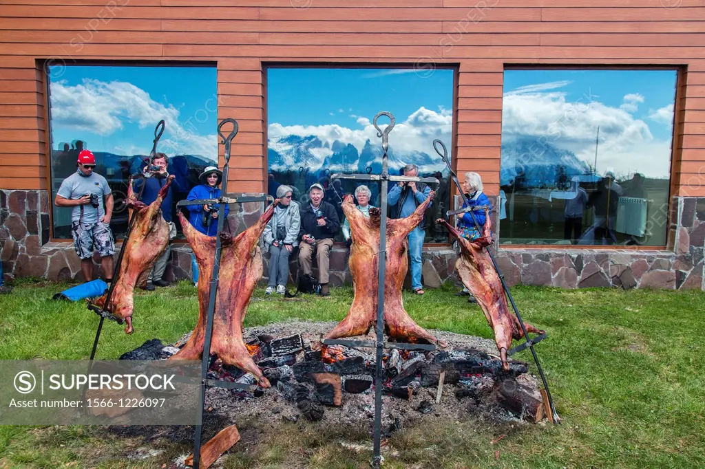 Lindblad guest at lamb roasting BBQ int Torres del Paine National Park, Patagonia, Chile