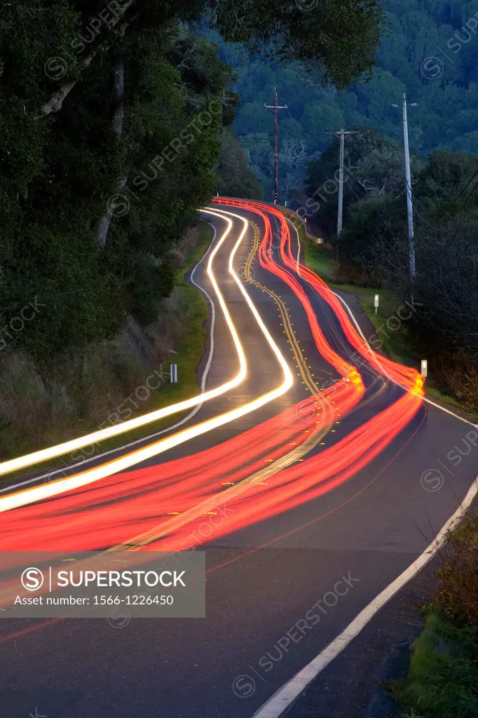 Point Reyes-Petaluma Road, Marin County, California, USA, with car headlight and tail light streaks at dusk