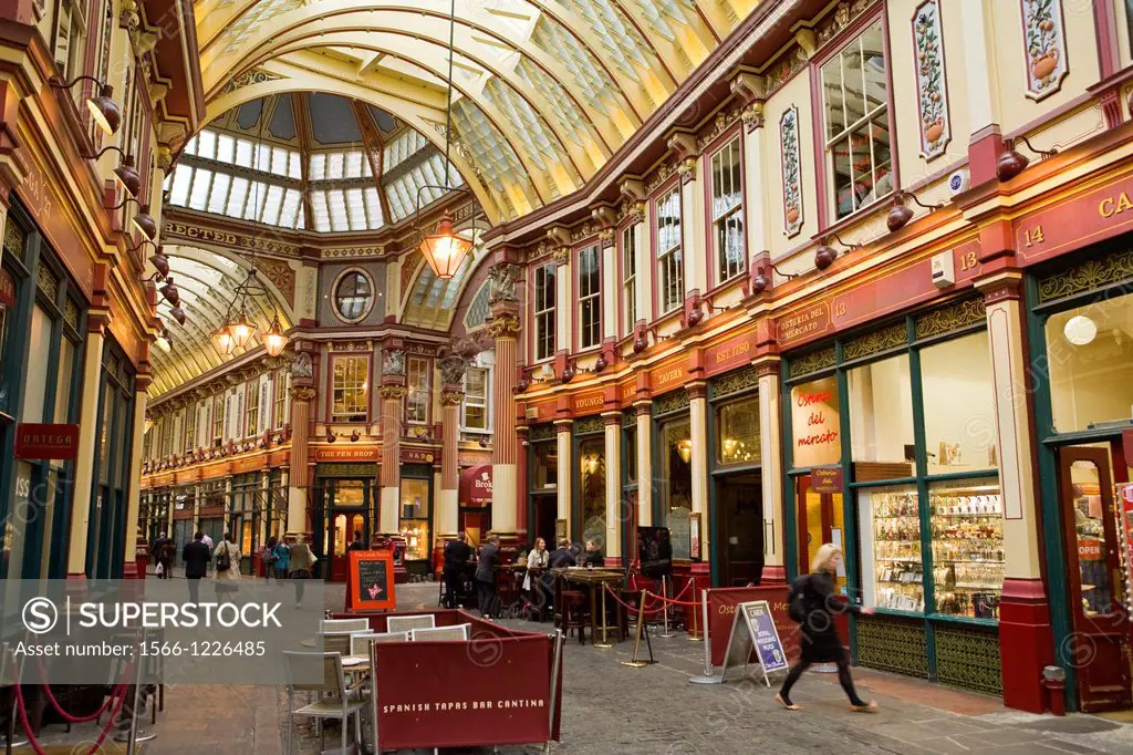 Business people and office workers drinking and shopping after work in Leadenhall Market designed 1881 by Sir Horace Jones, The City, London, England