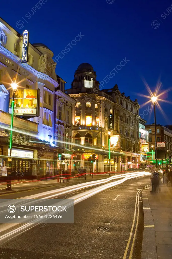 Shaftesbury Avenue theatre district, West End, London, England, with car light streaks, dusk