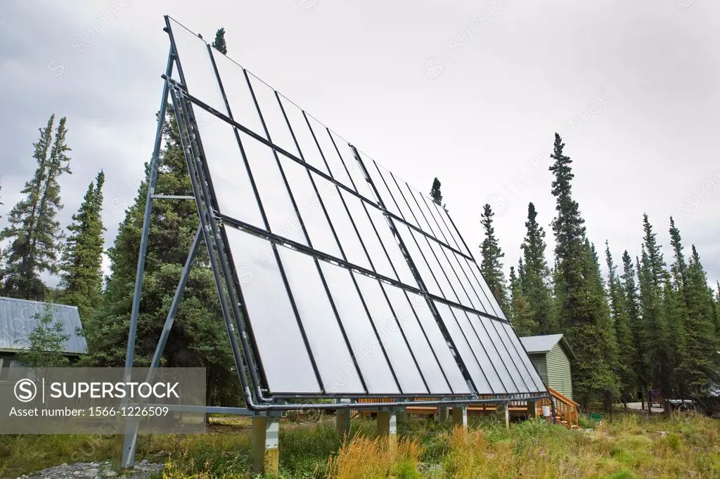 Solar water heating panels, spruce forest, at Denali Education Center, McKinley Village adjoining Denali National Park, Alaska, USA, late August