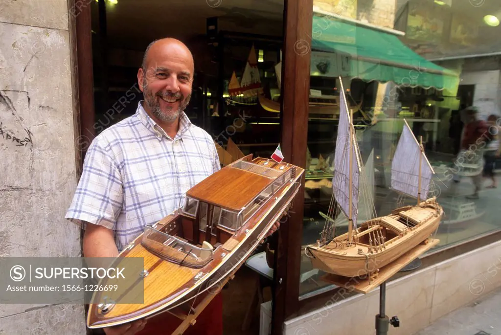 Mr Gilberto Penso holding one of his models, a Venetian taxi-boat, San Polo district, Venice, Veneto region, Italy, Europe