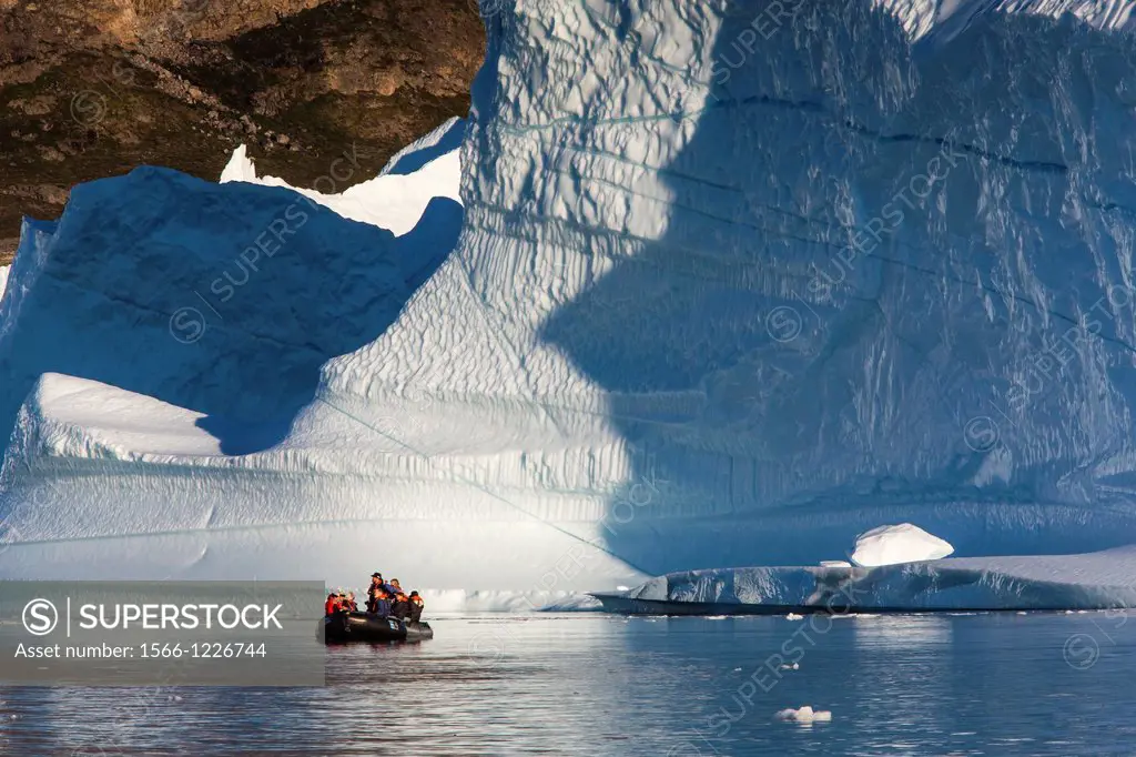 Zodiacs from the Lindblad Expeditions ship National Geographic Explorer amongst grounded icebergs near Rode O Red Island, Scoresbysund, Northeast Gree...