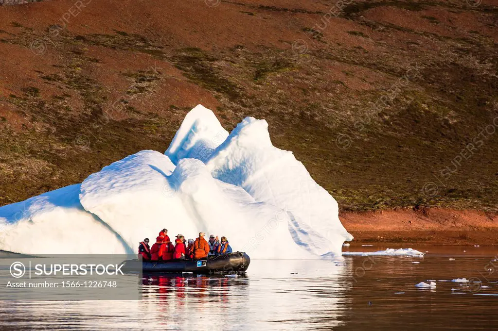 Zodiacs from the Lindblad Expeditions ship National Geographic Explorer amongst grounded icebergs near Rode O Red Island, Scoresbysund, Northeast Gree...