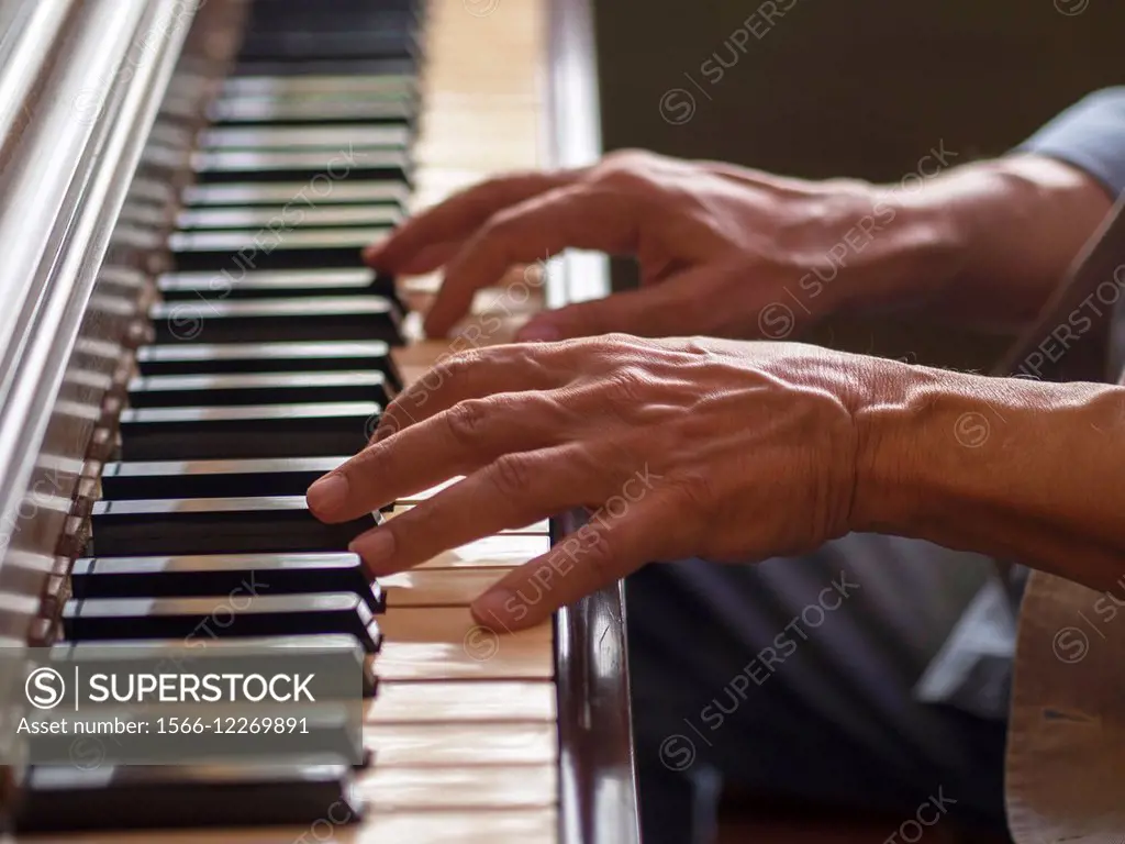 Hands of man playing piano in Providence, Rhode Island, United States.