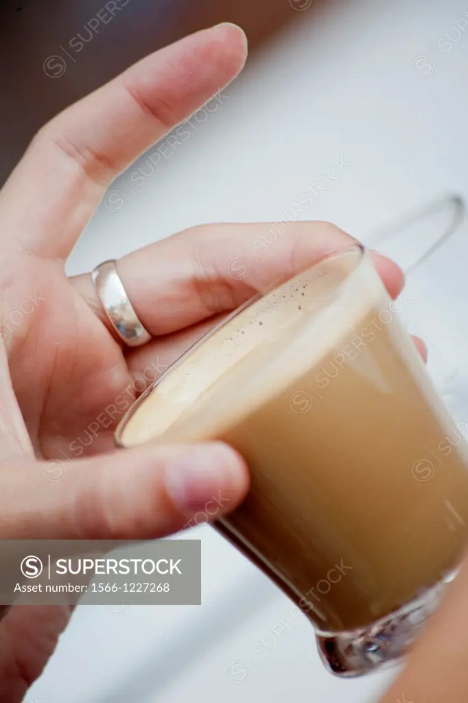 Hand and creamy coffe