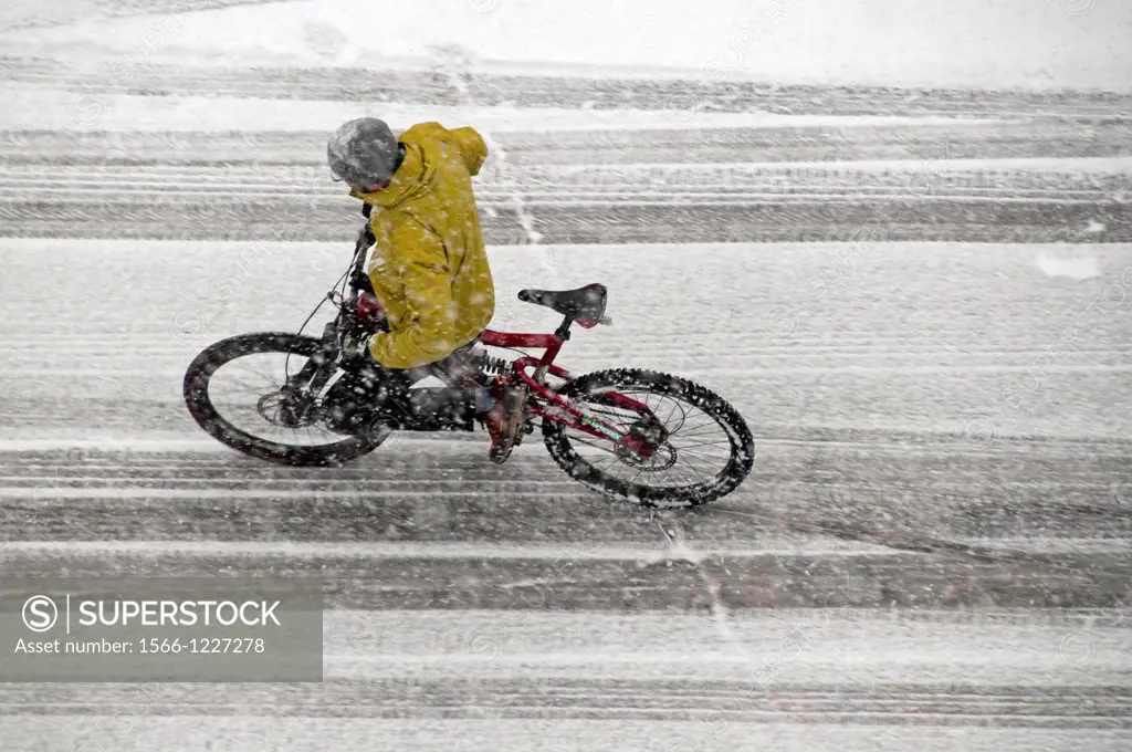 winter cycling problems on the street covered with fresh snow, Geneva, Switzerland